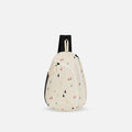 A Sherpani Wayfarer Terrazzo Print Convertible Sling, front view showing lockable pockets and main strap on white background. #color_terrazzo-print