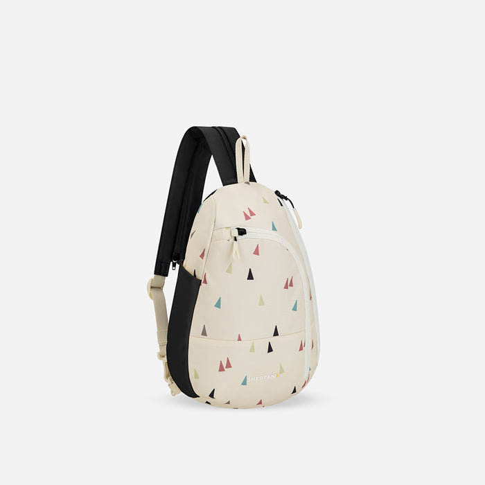 A Sherpani Wayfarer Terrazzo Print Convertible Sling, 3/4 view showing lockable pockets and main strap on white background. #color_terrazzo-print