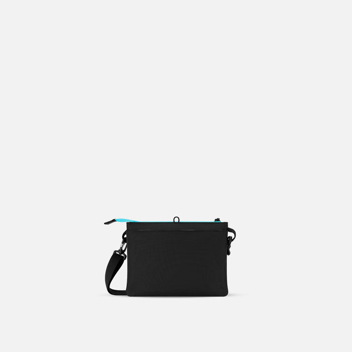 A Sherpani Zoom Chromatic Black Slim RFID Crossbody, back view against white background. #color_chromatic-black