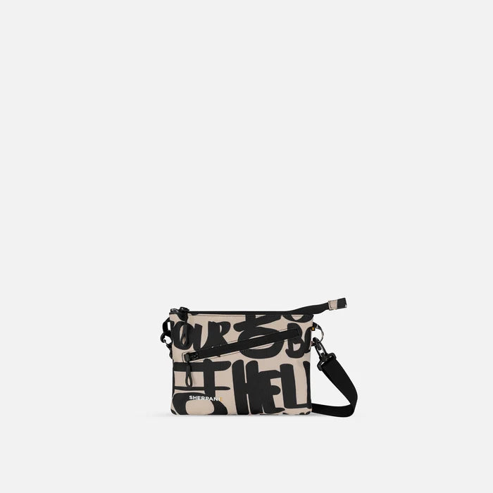 A Sherpani Zoom Ciao Slim RFID Crossbody, front view showing strap and pockets on white background.   #color_ciao-print
