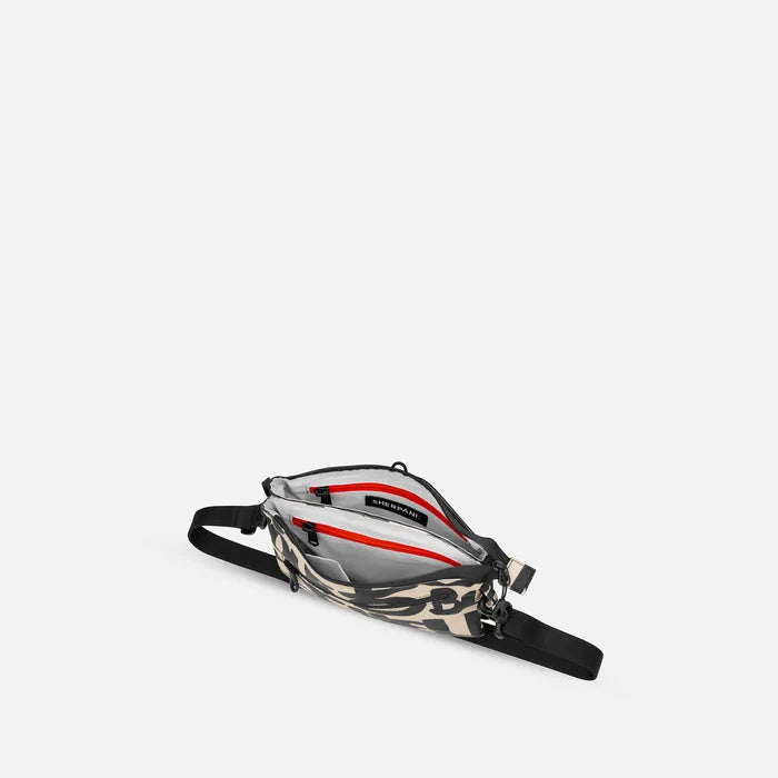 A Sherpani Zoom Ciao Slim RFID Crossbody, above view showing inside the two main pockets against white background. #color_ciao-print