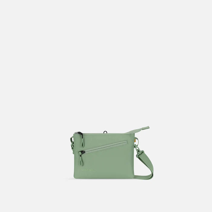 A Sherpani Zoom Olivine Slim RFID Crossbody, front view showing strap and pockets on white background.   #color_olivine-green
