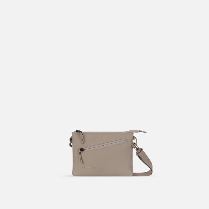 A Sherpani Zoom Dune Slim RFID Crossbody, front view showing strap and pockets on white background.   #color_dune-tan