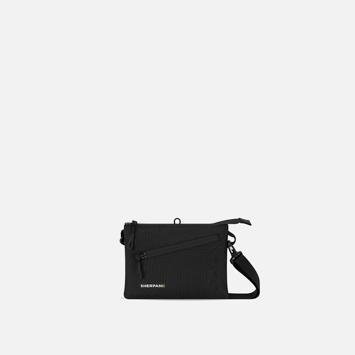 A Sherpani Zoom Raven Black Slim RFID Crossbody, front view showing strap and pockets on white background.  #color_raven-black