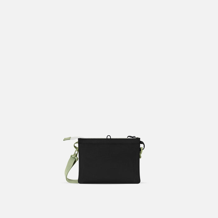 A Sherpani Zoom Palm Green Slim RFID Crossbody, back view against white background. #color_palm-green