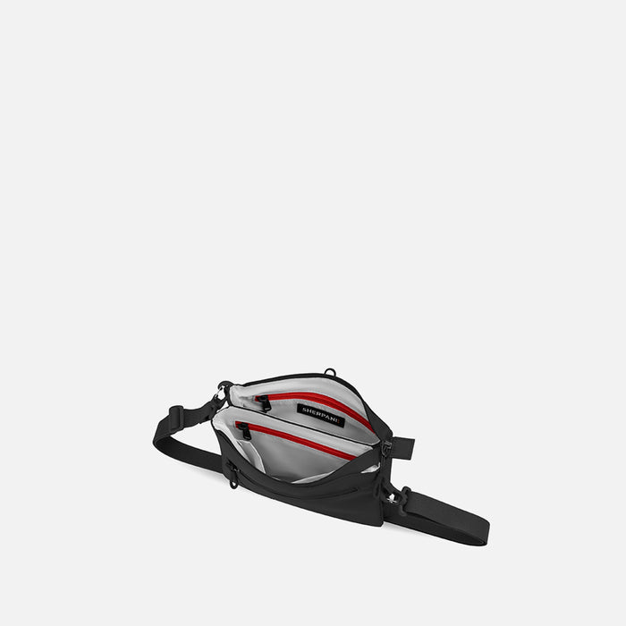A Sherpani Zoom Raven Black Slim RFID Crossbody, above view showing inside the two main pockets against white background.  #color_raven-black