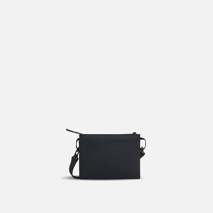A Sherpani Zoom Raven Black Slim RFID Crossbody, back view against white background. #color_raven-black