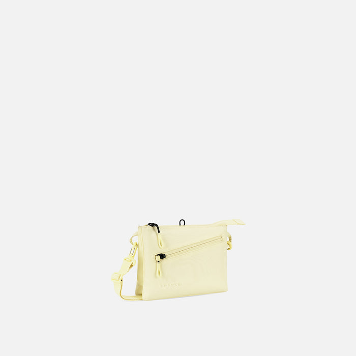 A Sherpani Zoom Sol Yellow Slim RFID Crossbody, 3/4 view showing lockable pocket and two main pockets on white background. #color_sol-yellow