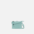 A Sherpani Zoom Surf Blue Slim RFID Crossbody, front view showing strap and pockets on white background.  #color_surf-blue