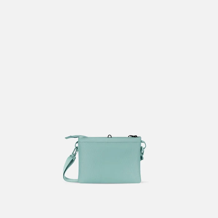 A Sherpani Zoom Surf Blue Slim RFID Crossbody, back view against white background. #color_surf-blue