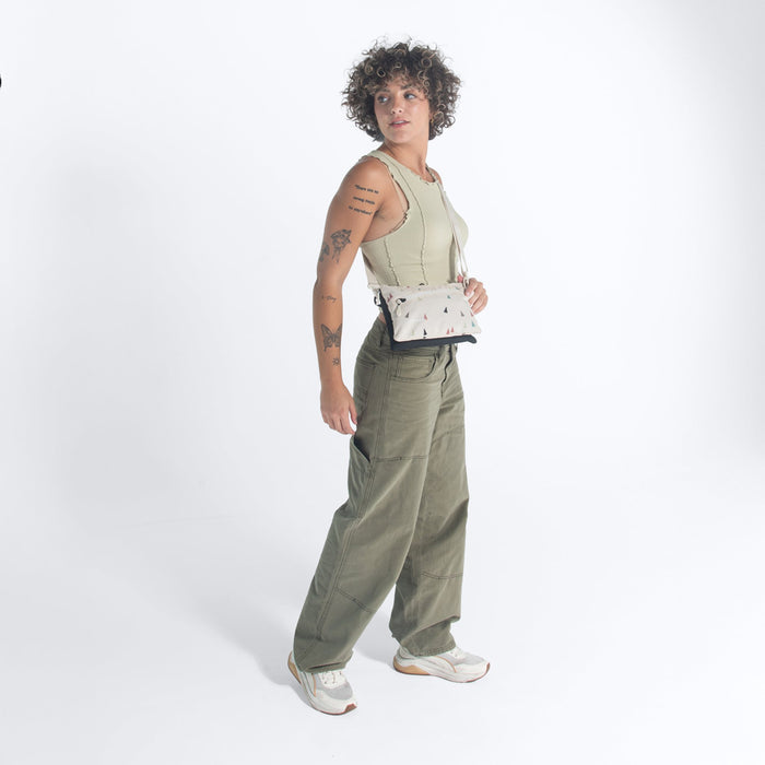 Woman wearing a Sherpani Zoom Terrazzo Print Slim RFID Crossbody against white background. #color_terrazzo-print