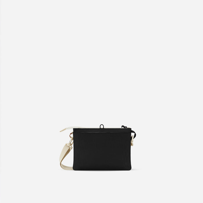 A Sherpani Zoom Terrazzo Print Slim RFID Crossbody, back view against white background. #color_terrazzo-print