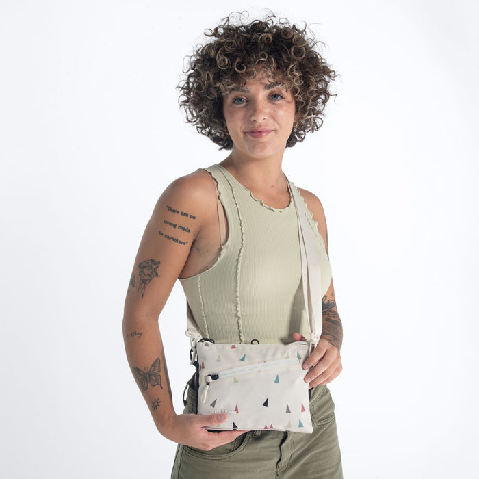 Woman wearing a Sherpani Zoom Terrazzo Print Slim RFID Crossbody against white background. #color_terrazzo-print